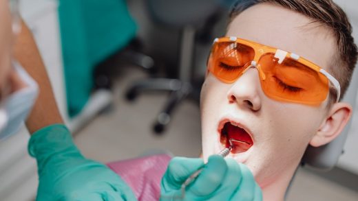 Patient in Glasses in Dentist Chair